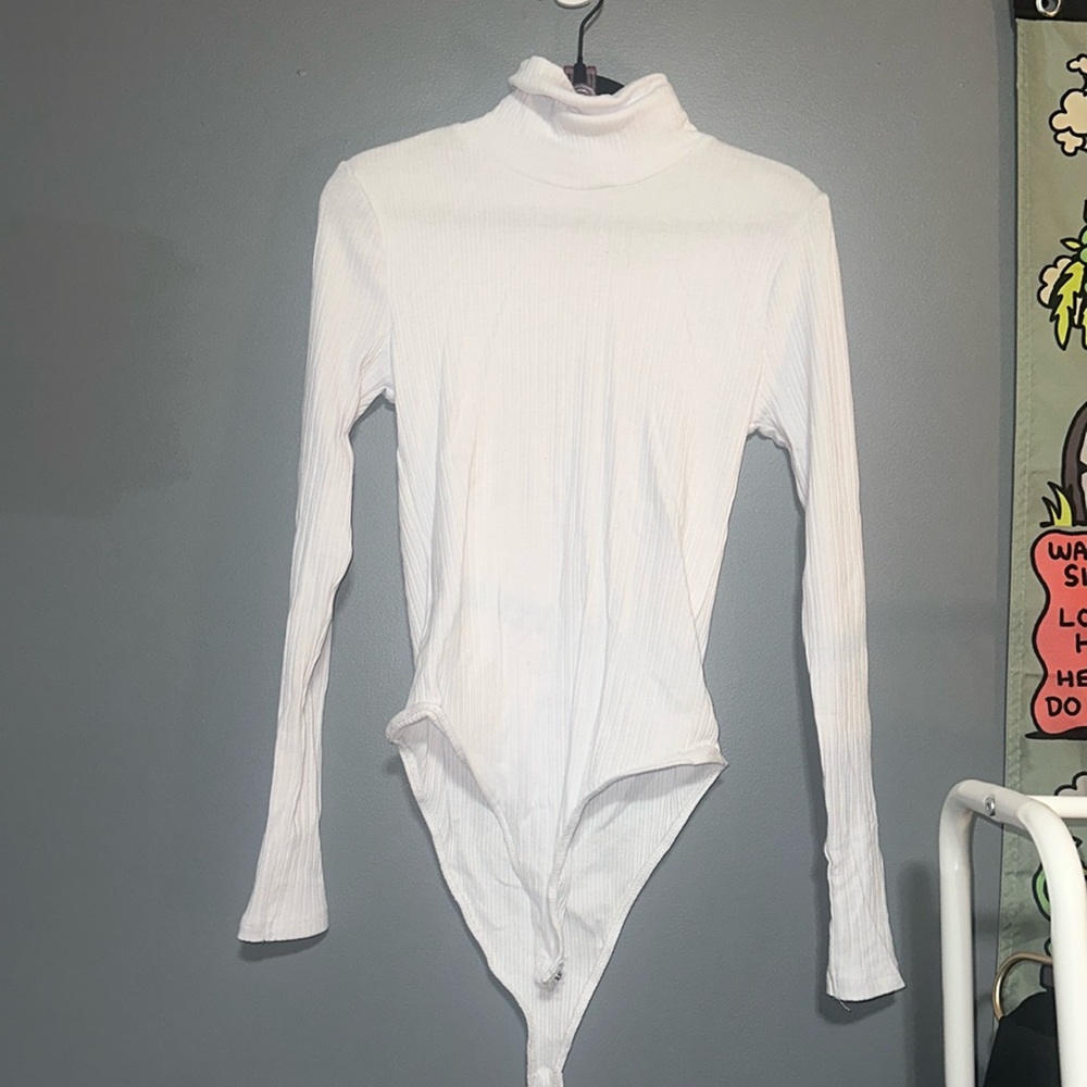 A white long-sleeved turtleneck bodysuit/one piece